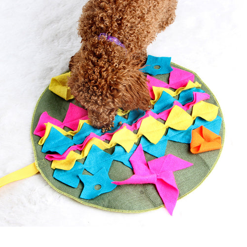 Dog sniffing for treats on a snuffle mat